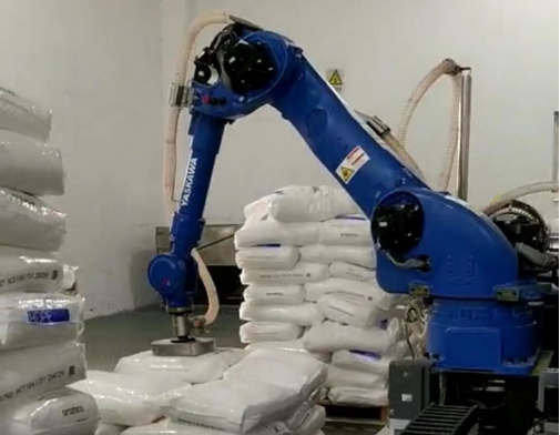 Bag breaking feeding robotic arm